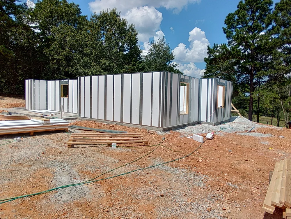 Crew installing roofing on panelized home