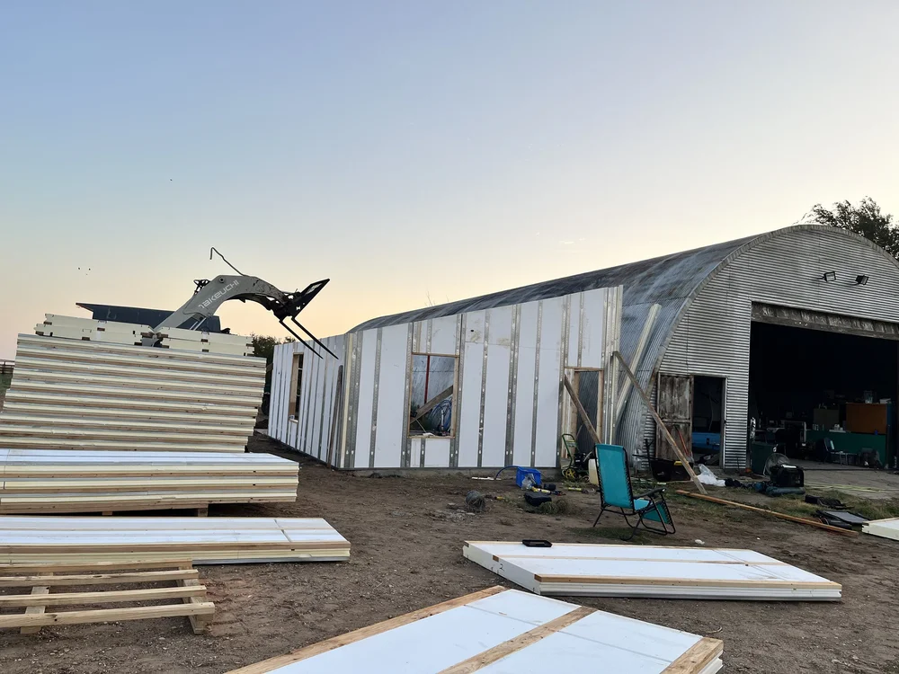 Hybrid panels with window openings at wooded site
